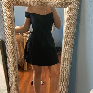 Black off the shoulder dress.